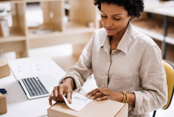 Woman confidently labeling and shipping e-commerce packages during peak season rush